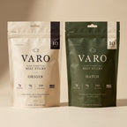ORIGIN and HATCH bags of VARO slow-fermented beef sticks side by side on a sand backdrop