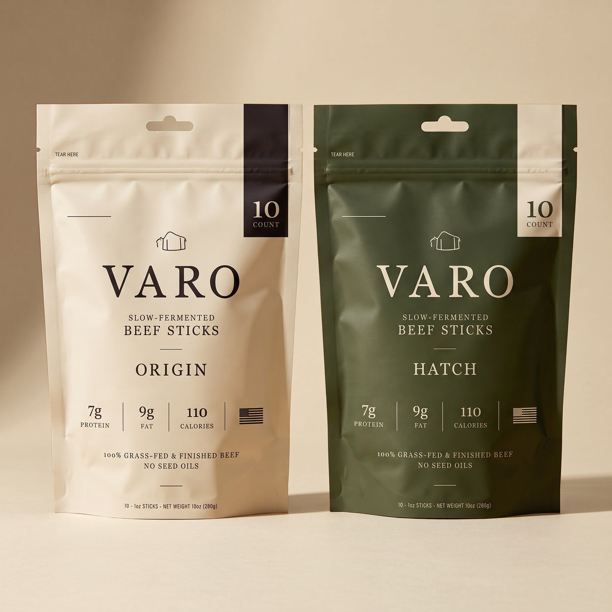 ORIGIN and HATCH bags of VARO slow-fermented beef sticks side by side on a sand backdrop