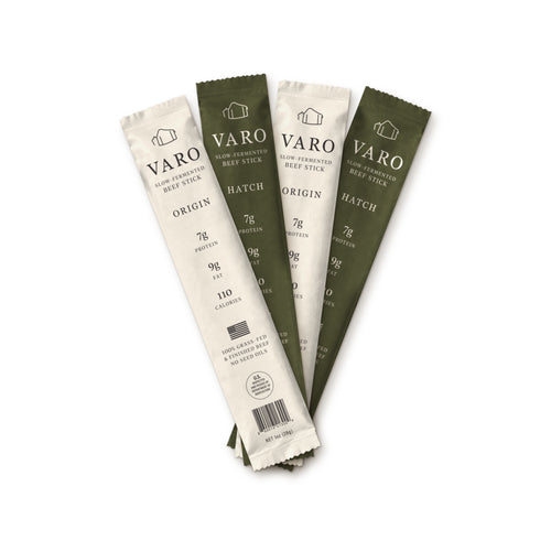 Four wrapped VARO slow-fermented beef sticks, two ORIGIN and two HATCH, fanned out